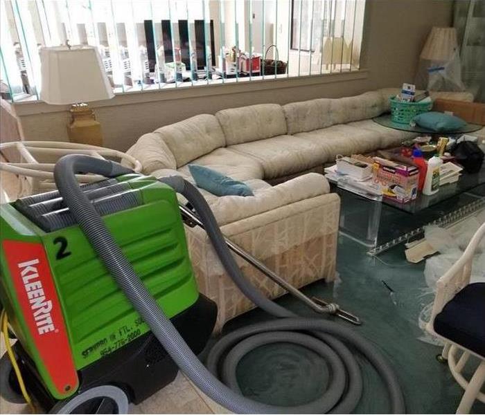 dehumidifier in a water damaged living room